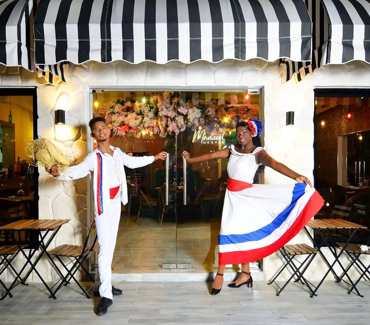 People in local dress inviting visitors to Mamiii Chula Restaurant at Playa Palmera Beach Resort
